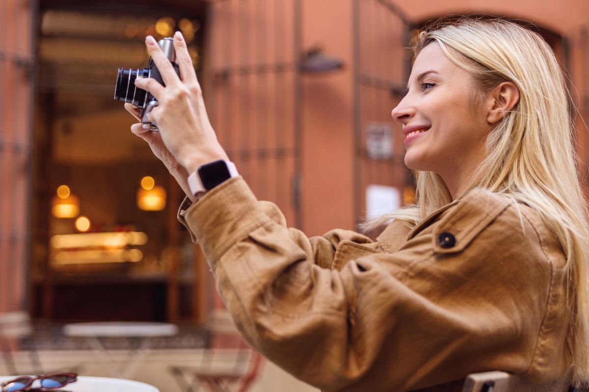 The woman is taking a picture.