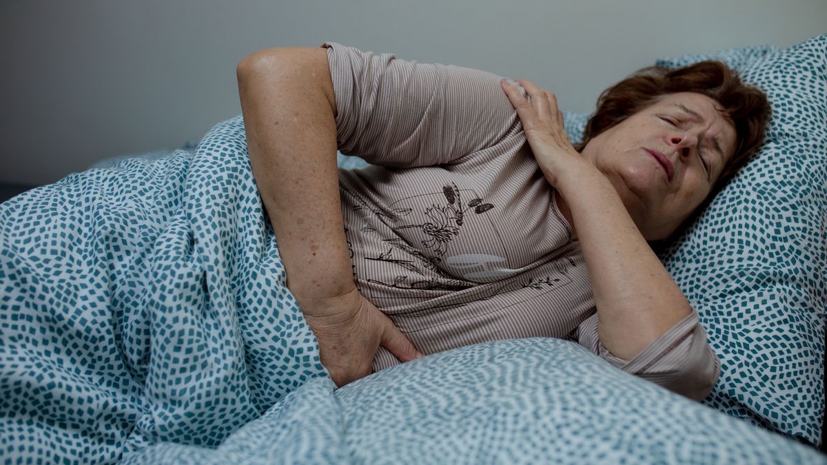 Senior woman with short hair lying in bed with hand on shoulder.
Old lady with short hair lying in bed holding one hand on shoulder, another on stomach. Woman fell off ladder while cleaning windows and got injured.
Tatsiana Volkava