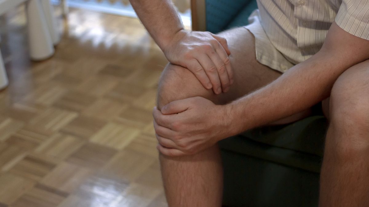 Closeup image of young man sitting on sofa and feeling knee pain
Closeup image of young man sitting on sofa and feeling knee pain and massage his knee at home.Cropped shot of unrecognizable man sitting on bed during his physiotherapy.Healthcare and medical concept
Jelena Stanojkovic