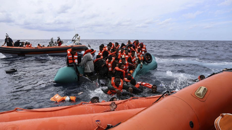 arch47Migrants aboard a precarious rubber boat end up in water before being rescued by a team of the Sea Watch-3, around 35 miles away from Libya, in Libyan SAR zone, Monday, Oct. 18, 2021. (AP Photo/Valeria Mongelli)AP