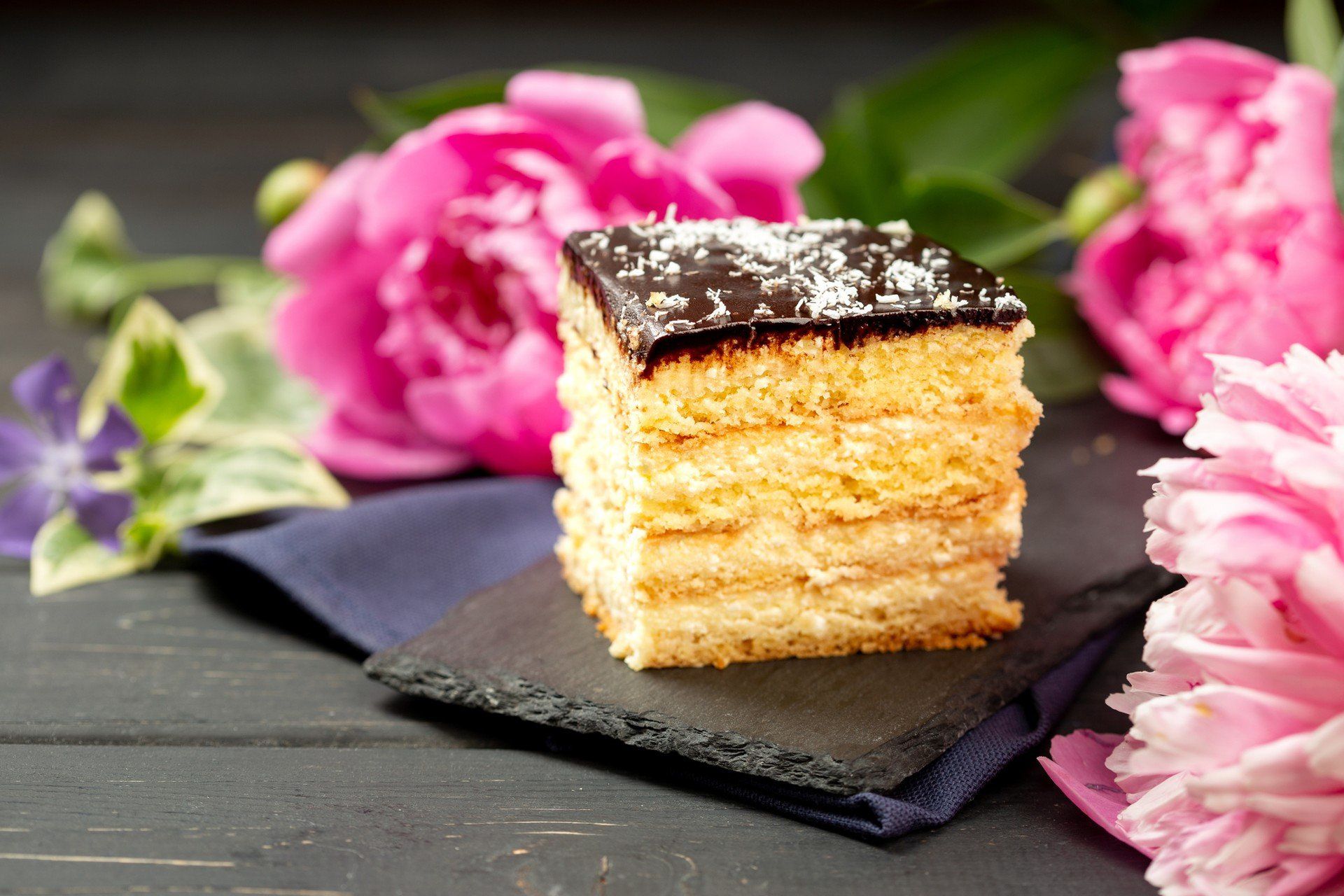 A piece of cheesecake on slate plate