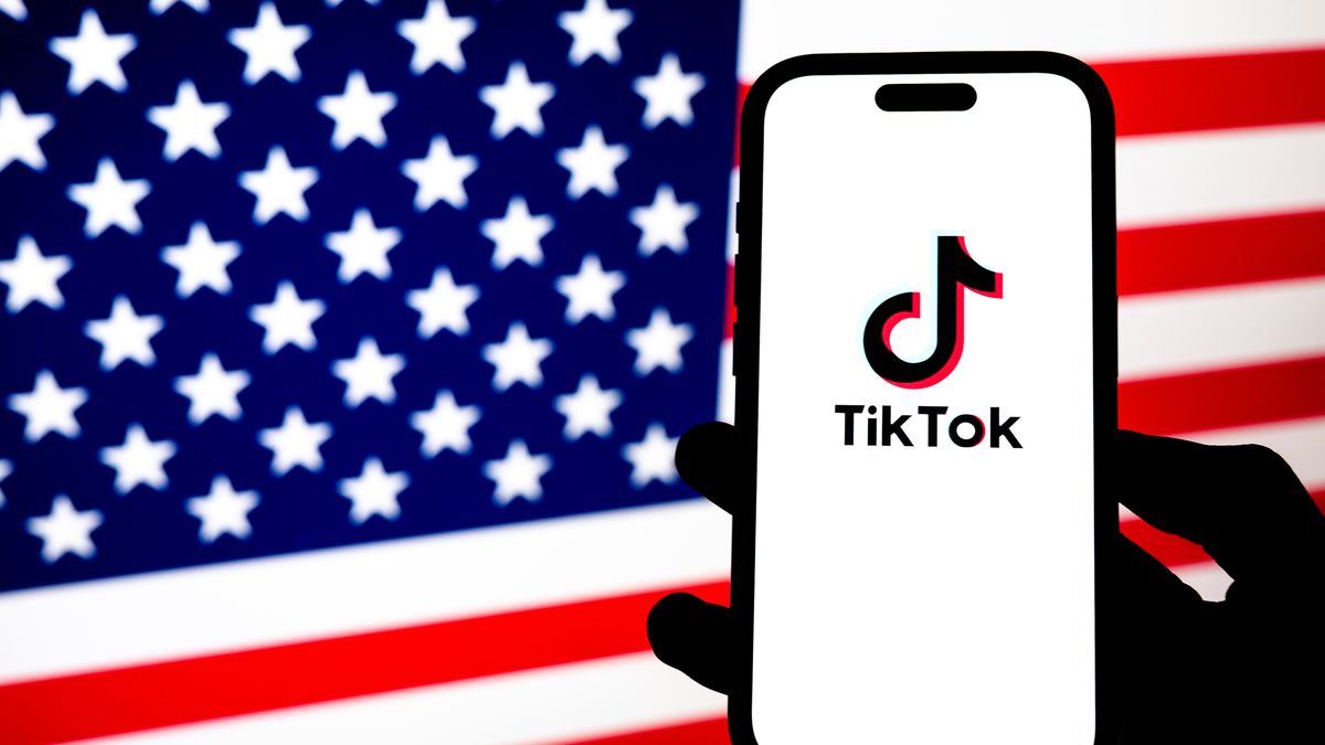 ANKARA, TURKIYE - JANUARY 6: In this photo illustration, US flag is being displayed on a mobile phone screen in front of a computer screen displaying TikTok logo in Ankara, Turkiye on January 6, 2026. (Photo by Ismail Aslandag/Anadolu via Getty Images)