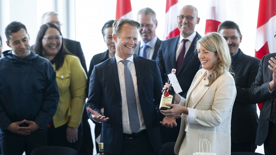 TemporaryDanish Foreign Minister Jeppe Kofod, center, and Canada's Canadian Foreign Minister M�lanie Joly, right, trade gifts of liquor after the signing of an agreement that will establish a land border between Canada and the Kingdom of Denmark on Hans Island, an arctic island between Nunavut and Greenland, on Tuesday, June 14, 2022, in Ottawa. (Justin Tang/The Canadian Press via AP)The Canadian Press