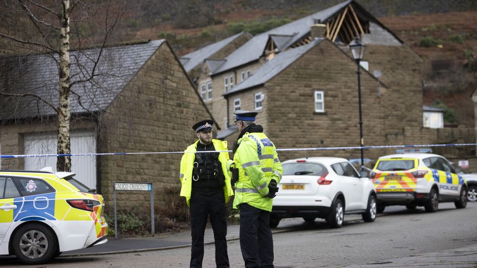 STALYBRIDGE, ENGLAND - DECEMBER 28: Police guard the scene in Carbrook Village where houses can be seen damaged in the aftermath of a tornado on December 28, 2023 in Stalybridge, England. Houses in the Tameside area of Greater Manchester have been damaged by a localised tornado during Storm Gerrit. Police declared a major incident last night as roofs were torn off the houses and trees uprooted, but no reported injuries. (Photo by Ryan Jenkins/Getty Images)