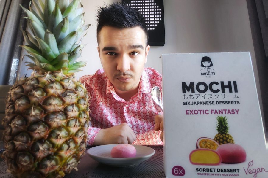 Opakowanie lodów Mochi, ananas i jedzący je człowiek