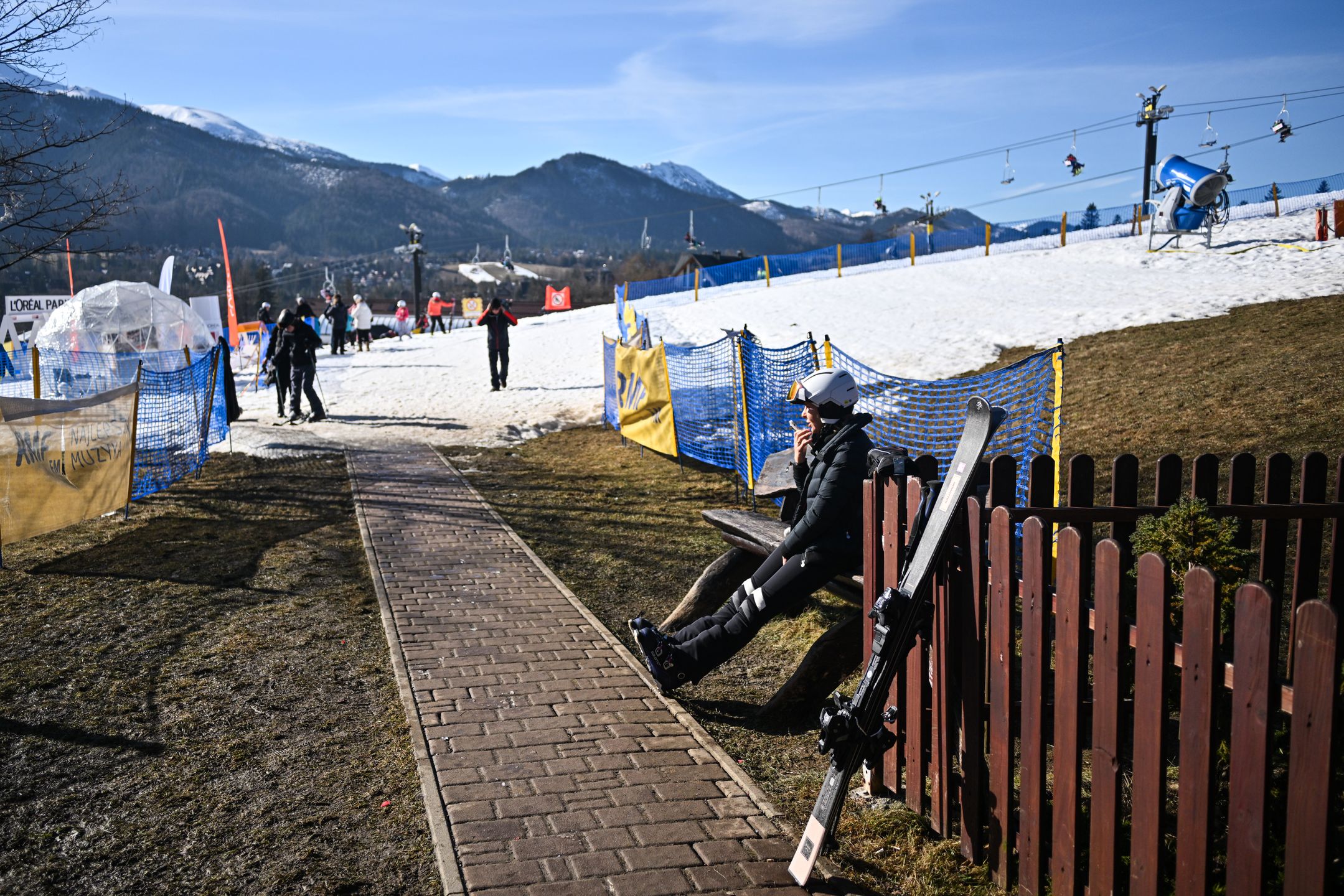 ZAKOPANE, POLAND - FEBRUARY 16: People get ready to practice on a ski sloop operating with a small amount of snow during an unusually high-temperature day in Zakopane, Poland on February 16, 2024. Poland is now having unusually warm temperatures, during a time, when Zakopane is full of snow and negative temperatures. All snow has melted during the past few days and one of the main attractions, the snow maze is melting and a reduced price has been introduced by the organizers. According to the European Union's Copernicus Climate Change Service, the period between February 2023 and January 2024 is the hottest 12-month period ever measured. During this time, global average temperatures rose 1.52 degrees Celsius. The 1.5 Celcius degrees boundary stands out because it was a limit established as part of the 2015 Paris climate agreement. (Photo by Omar Marques/Anadolu via Getty Images)