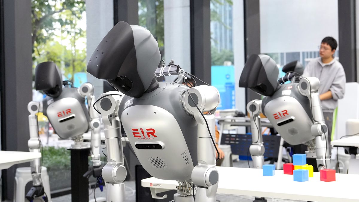 CHENGDU, CHINA - OCTOBER 27: An engineer trains humanoid robots at a humanoid robot training facility on October 27, 2026 in Chengdu, Sichuan Province of China. The site serves as a demonstration platform for the Sichuan Embodied Intelligent Robot Technology Co., Ltd., featuring products including the emotional interaction robot 'Aiqiu', the quadruped robot 'Tianxun', and the full-size general humanoid platform 'Skywalker'. (Photo by An Yuan/China News Service/VCG via Getty Images)