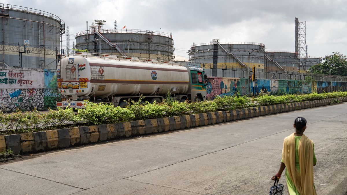 An oil tanker passes storage tanks at a Bharat Petroleum Corp. oil refinery in Mumbai, India, on Monday, Aug. 11, 2025. India's state-owned oil refiners are pulling back from purchases of Russian crude for now, according to people with direct knowledge of the companies' procurement plans, as Washington ratchets up the pressure on New Delhi over the flows with a wave of harsh tariffs. Photographer: Abeer Khan/Bloomberg via Getty Images