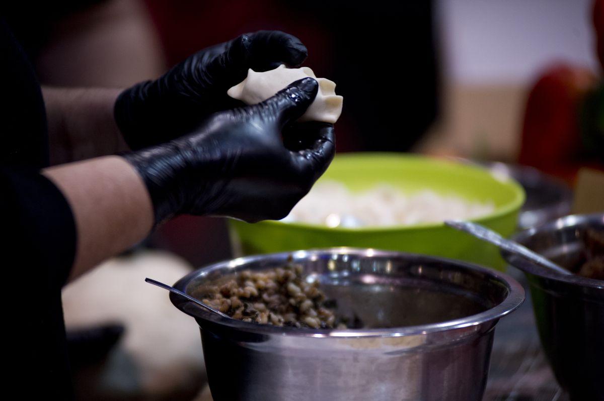 A cook makes traditional Polish pierogi during the world's dumplings festival in Warsaw, Poland on November 09, 2019. (Photo by Aleksander Kalka/NurPhoto via Getty Images)