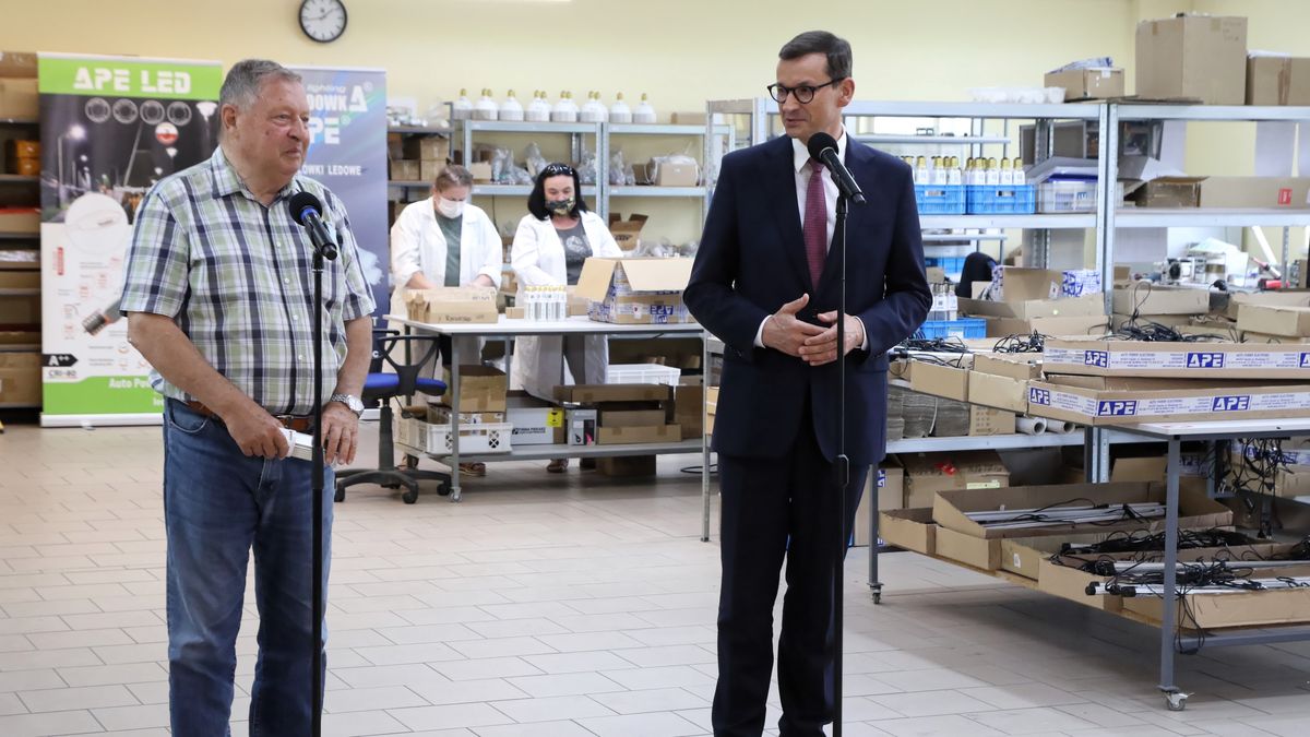 Opole, 16.08.2021. Premier Mateusz Morawiecki (P) oraz założyciel i prezes firmy APE Piotr Skrobotowicz (L) podczas wizyty w siedzibie firmy APE LED w Opolu, 16 bm. Premier Morawiecki przebywa z wizytą w województwie opolskim. (jm) PAP/Krzysztof Świderski