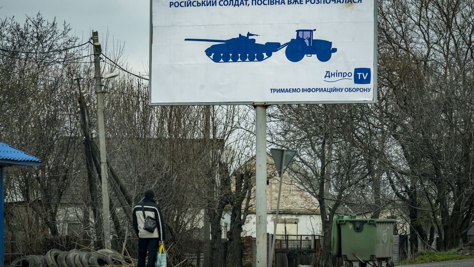 A man looks a ironic banner in Dnipro city saying: &quot;russian soldier, sowing campaign has already begun&quot;, in reference to the famous snapshots of ukrainian tractors pulling of abandoned russian tanks during the rusian invasion on Ukraine. (Photo by Celestino Arce/NurPhoto via Getty Images)