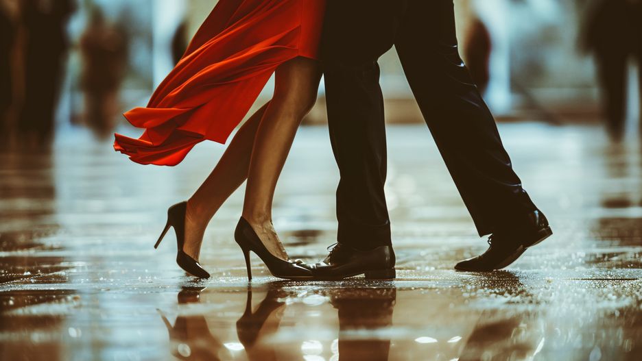 legs, man, woman, dancing, tango, bright red dress, black slacks, dress shoes, passion, movement, elegance, rhythm, partnership, connection, sensual, allure, performance, dance floor, argentine tango, dramatic, intensity, intimacy, expression, grace, sophistication