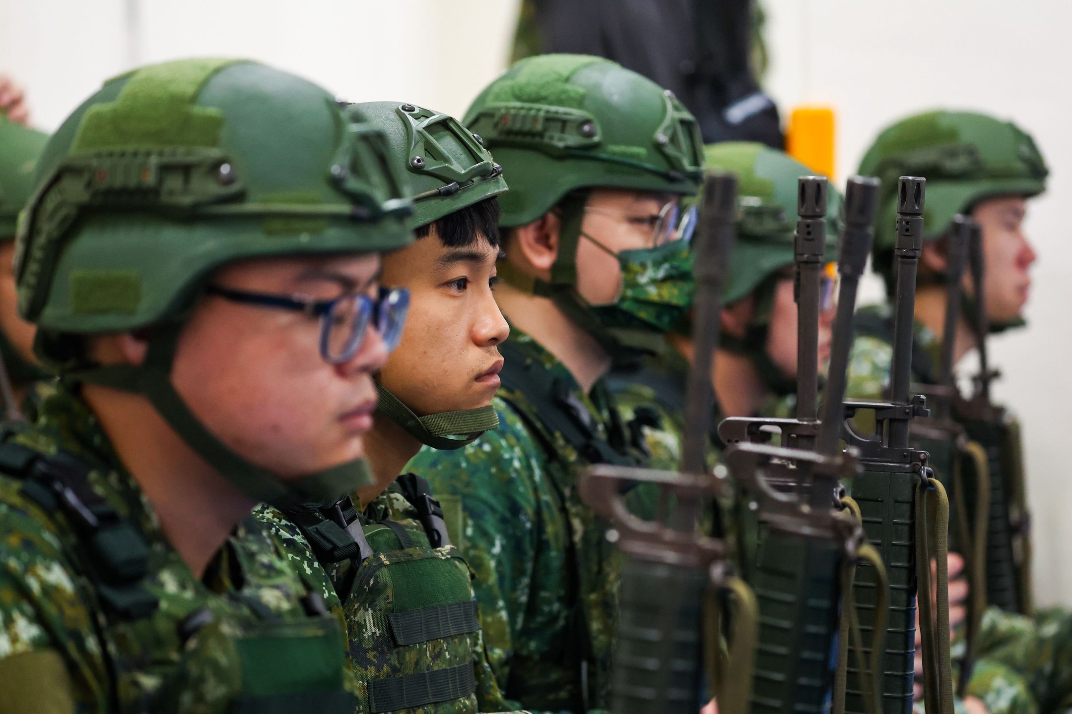 MIAOLI, TAIWAN - JULY 09: Taiwanese reservists partake in a pre-combat exercise held at a primary school, as the Han Kuang military exercise commences, in Miaoli, Taiwan, on July 09, 2025. Dubbed the biggest-ever version of its kind, the exercise, with a focus on 'Urban Resilience', will run day and night from July 09 through July 18. A huge number of regular personnel, advanced weapons acquired from the United States including the HIMARS missile systems and the M1A2T tanks, as well as 22,000 reservists are to be deployed. This comes as Taipei is bracing for a possible invasion by Beijing, after China stepped up activities of the People's Liberation Army around the self-governing island, with Chinese President Xi Jinping vowing not to give up the option to invade the island by force. (Photo by Daniel Ceng/Anadolu via Getty Images)