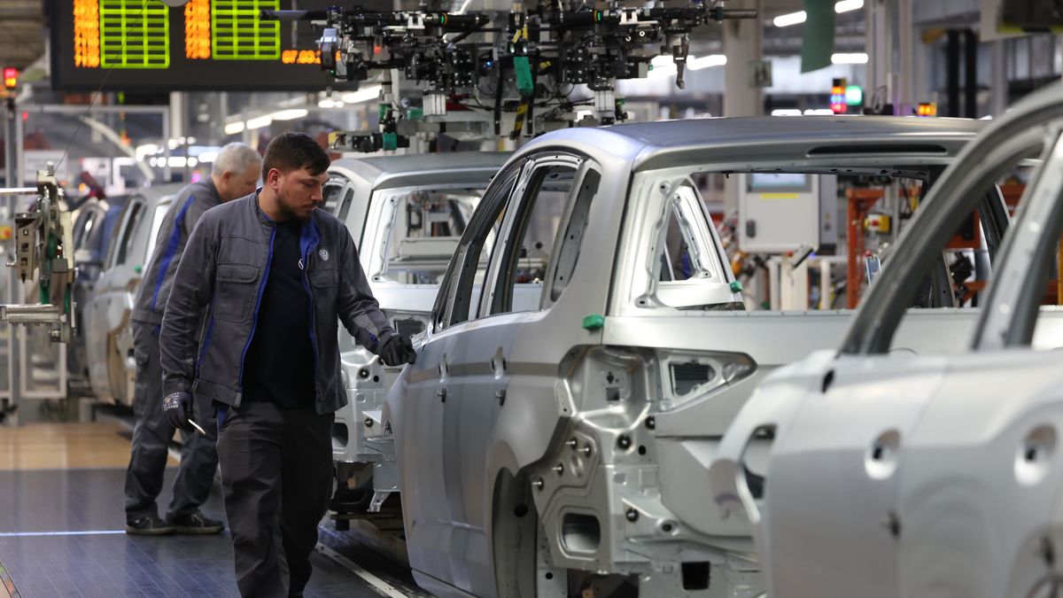 WOLFSBURG, GERMANY - MARCH 07: Workers assemble cars on the assembly line at the Volkswagen automobile factory on March 07, 2025 in Wolfsburg, Germany. The factory, which produces the gasoline-powered and hybrid Golf, Tiguan, Touran and Tayron models, churns out over half a million cars a year. Volkswagen faced a sharp decline in global sales last year. The company is seeking to reduce its work force and possibly close some of its German factories. Production at the Wolfsburg plant, however, rose in 2024. (Photo by Sean Gallup/Getty Images)