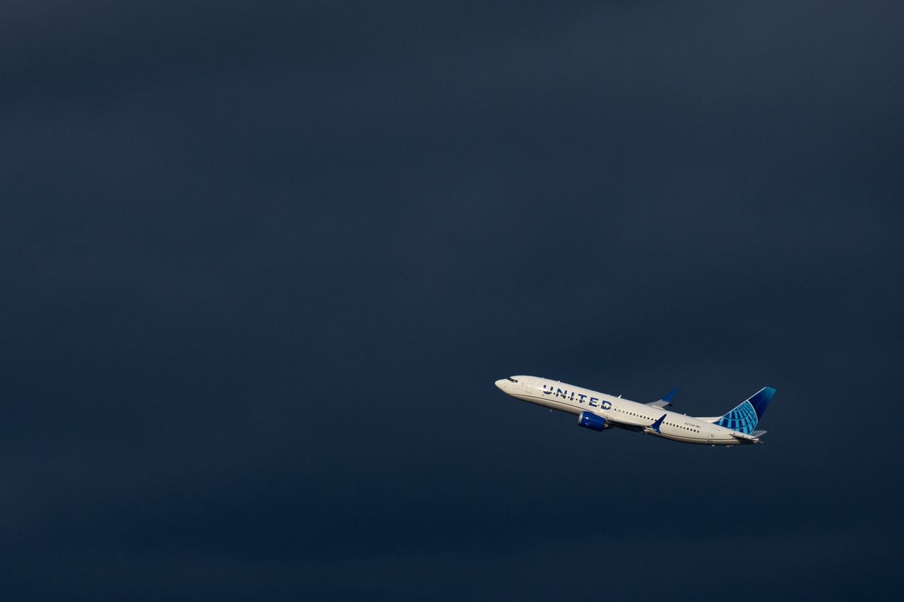 WASHINGTON - MARCH 23: A United Airlines Boeing 737 MAX 8 plane takes off past dark rain clouds from Ronald Reagan Washington National Airport in Arlington, Va., on Saturday, March 23, 2024. (Bill Clark/CQ-Roll Call, Inc via Getty Images)