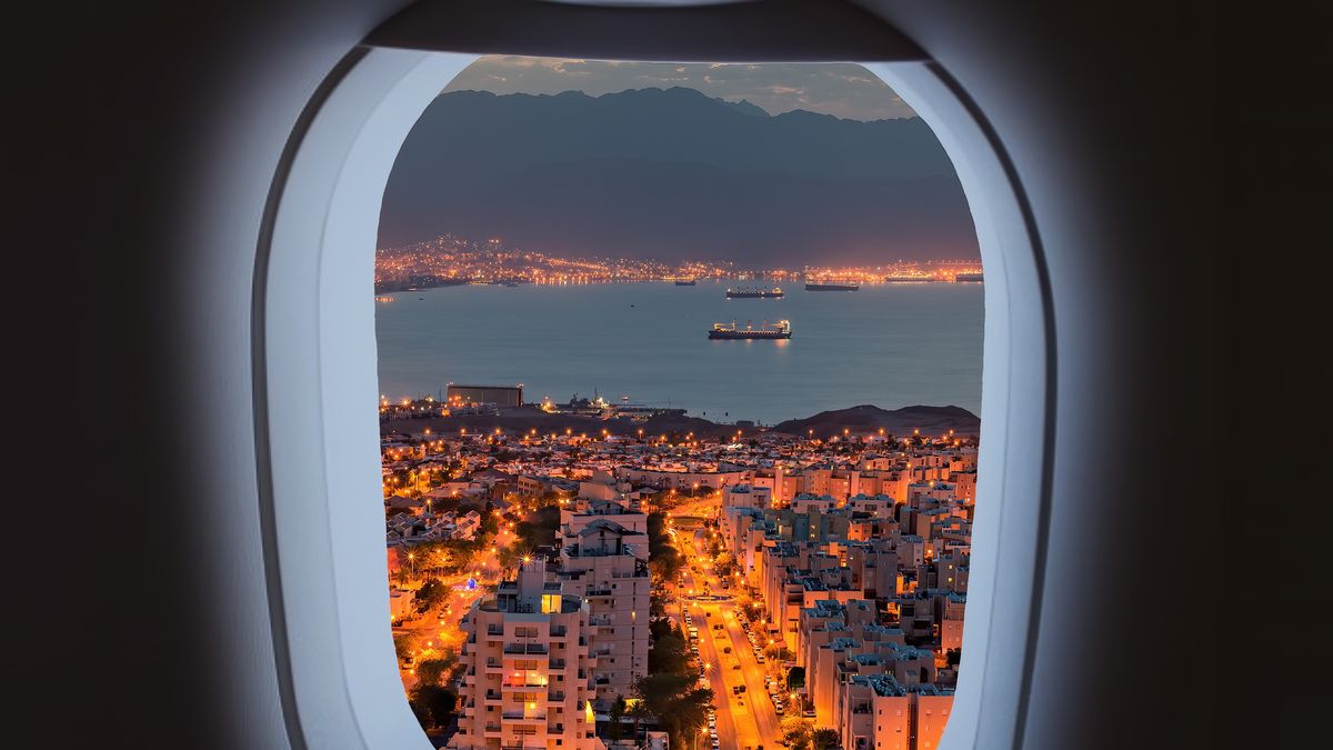Aerial view of window from landing airplane, night Eilat and Aqaba cities
Aerial view of window from landing airplane, night Eilat and Aqaba cities surrounding the Red Sea and marine port with cargo ships, Middle East
gorsh13