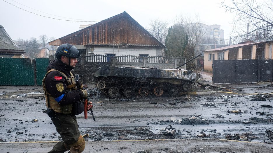 Ukrainian soldier inspects the wreckage of a destroyedBUCHA, UKRAINE - 2022/04/03: Ukrainian soldier inspects the wreckage of a destroyed Russian armored column on the road in Bucha, a suburb north of Kyiv. As Russian troops withdraw from areas north of Ukraine's capital city of Kyiv, Ukrainian forces and the media found evidence of significant numbers of civilian casualties. The Ukrainian authorities are calling the killing of civilians in Bucha and other areas a war crime. (Photo by Matthew Hatcher/SOPA Images/LightRocket via Getty Images)SOPA Imagesarmored column, attack, bucha, damage, destroyed, devastation, inspects, invasion of ukraine, military action, ruin, russian, russian invasion, shell, shelling, soldier, soldiers, tragedy, ukrainian, victims, war against ukraine, war crimes, wreckage