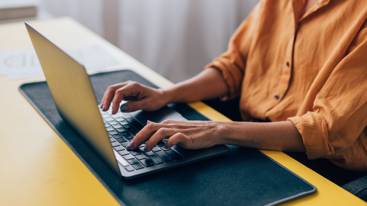 Professional Woman Working on Laptop at Modern Workspace
Close-up of a woman in a yellow shirt typing on a laptop, situated at a vibrant workspace with paperwork around.
FreshSplash