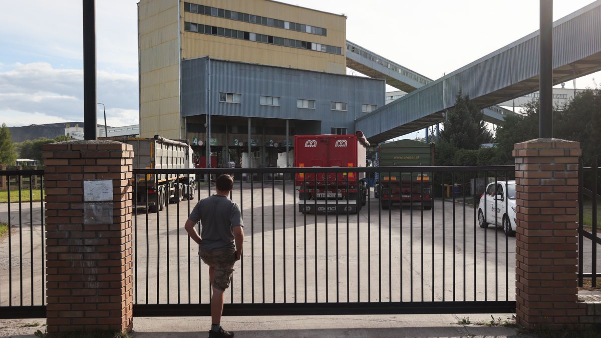 BOGDANKA, POLAND - AUGUST 31: A man stands near the gate of the coal mine in Bogdanka, Poland on August 31, 2022. The growing demand for coal in Poland caused vehicle lines outside the mine's sales office. In recent days, the Bogdanka coal mine has introduced registrations for coal collection, which helped to reduce queues. (Photo by Jakub Porzycki/Anadolu Agency via Getty Images)