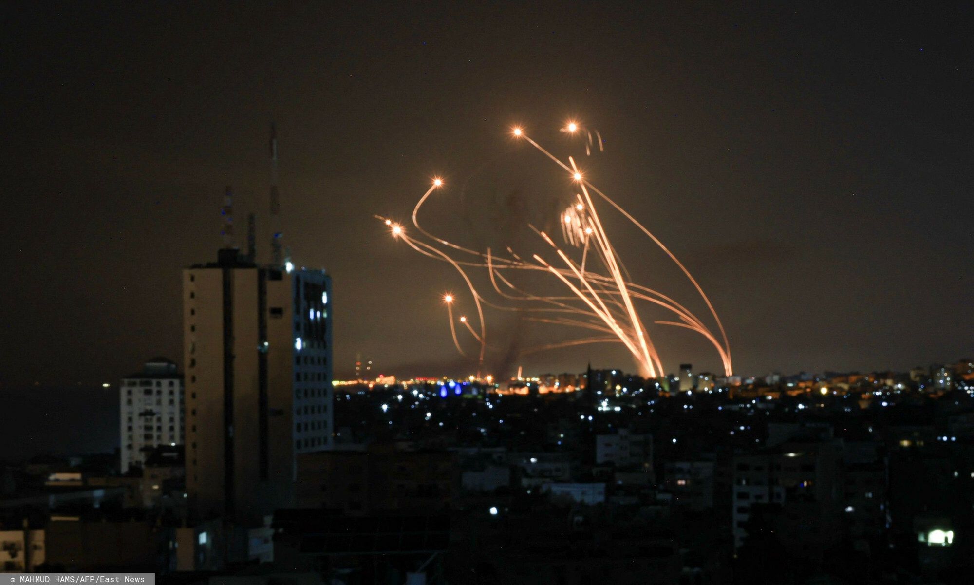 Temporary
An Israeli missile launched from the Iron Dome defence missile system attempts to intercept a rocket, fired from the Gaza Strip, over the city of Netivot in southern Israel on October 8, 2023. Israel, reeling from the deadliest attack on its territory in half a century, formally declared war on Hamas Sunday as the conflict's death toll surged close to 1,000 after the Palestinian militant group launched a massive surprise assault from Gaza. (Photo by MAHMUD HAMS / AFP)
MAHMUD HAMS
