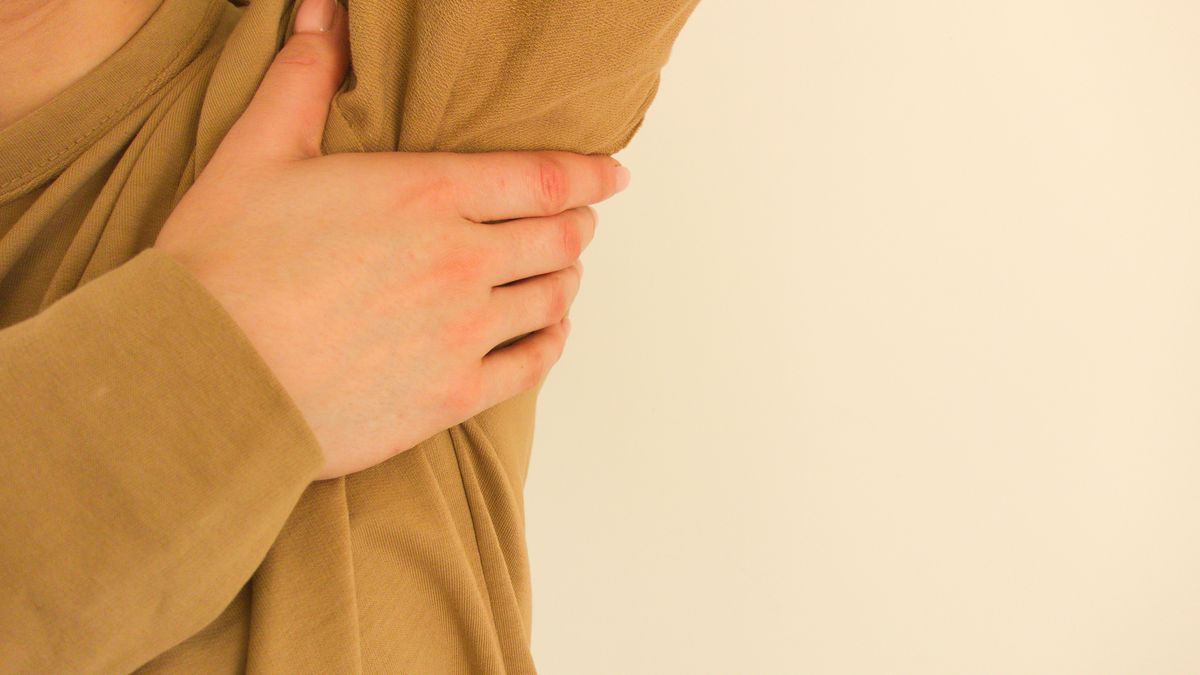 Woman suffers from pain in the armpitWoman suffers from pain in the armpit. Sweating, unpleasant odor, inflammation, breast cancer prevention conceptPiotrekswat