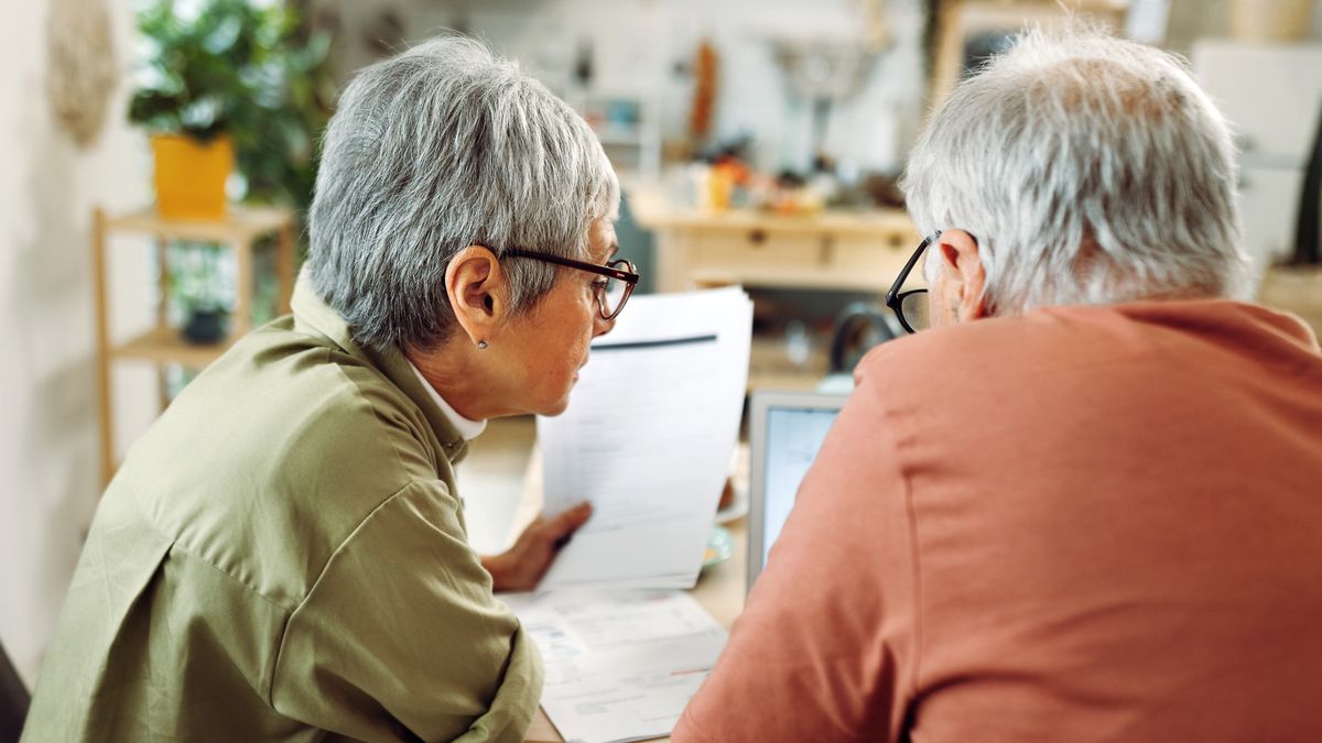 Senior couple going over bills at home
Rear view of casually clothed senior couple going over paperwork at home
mixetto