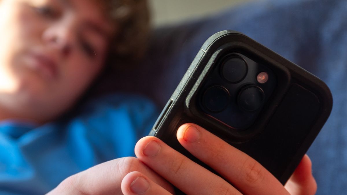 BATH, UNITED KINGDOM - NOVEMBER 30: A 14-year-old boy looks at a iPhone screen on November 30, 2024 in Bath, England. The Australian Senate passed a law to ban children under 16 from having social media accounts and social media platforms, including TikTok, Facebook, Snapchat, Reddit, X, formerly Twitter, and Instagram potentially being be fined for preventing children younger than 16 from having social media accounts. (Photo by Anna Barclay/Getty Images)