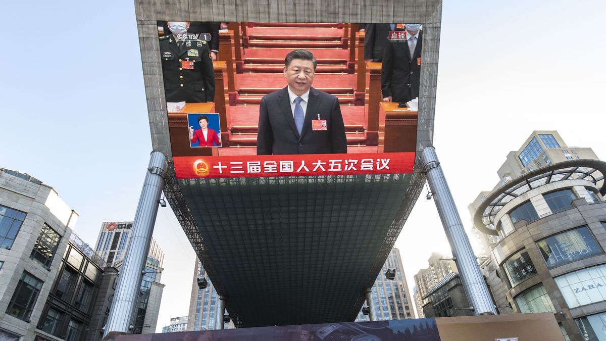 A screen displays a live news broadcast of Chinese President Xi Jinping at the National People's Congress in Beijing, China, on Saturday, March 5, 2022. Chinas government signaled more stimulus is on the cards by setting an economic growth target at the upper end of economists projections. Photographer: Qilai Shen/Bloomberg via Getty Images