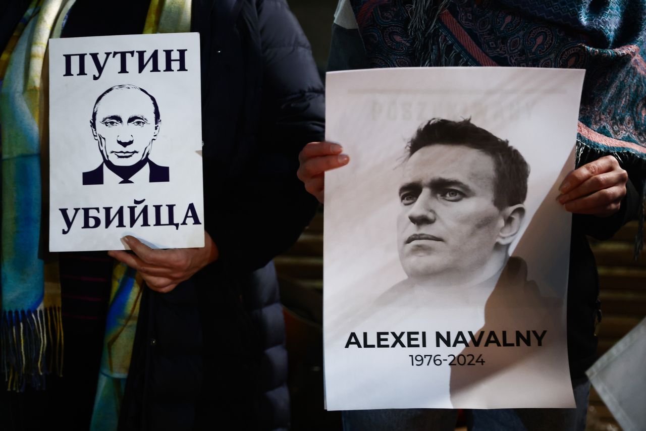 People hold banners during a vigil for Alexiei Navalny in front of the Russian Consulate General in Krakow, Poland on February 16, 2024. Navalny, 47, Russian opposition politician, died this morning in the Russian prison about 40 miles north of the Arctic Circle, where he had been sentenced to 19 years. (Photo by Beata Zawrzel/NurPhoto via Getty Images)