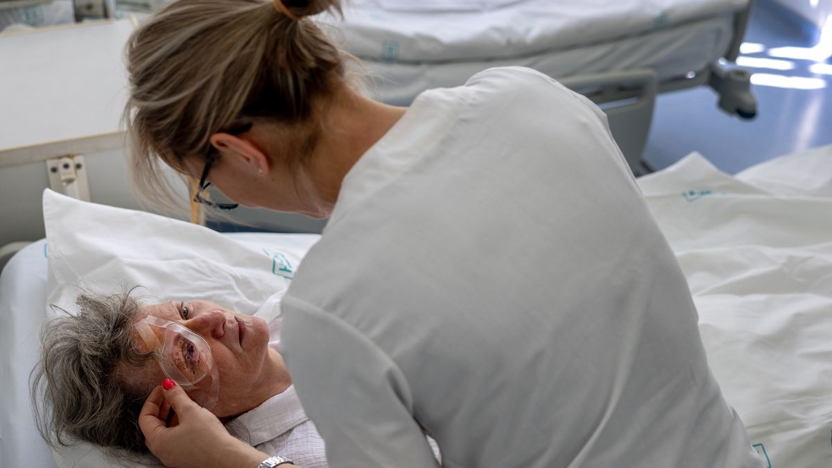 BUDAPEST, HUNGARY - MAY 13: Head nurse of ophthalmology Kucsera Bogati soothes patient Lajosne Kokai after a procedure at Saint John's Hospital on May 13, 2026 of Budapest, Hungary. Partially refurbished with European Union grants, the hospital serves more than one million Hungarians. The EU cut off continued funding for infrastructure projects nationwide in Hungary, after the former government of Viktor Orban was sited for massive state corruption. Hungary's new Prime Minister Peter Magyar is looking to restore EU funding as soon as possible to deliver on campaign promises to improve the nation's health care, including completing improvements to key hospitals like Saint John's. Hungary has entered a new political era after the defeat of the architect of a self-described "illiberal democracy"  Victor Orban, who led the country for 16 years. (Photo by John Moore/Getty Images)