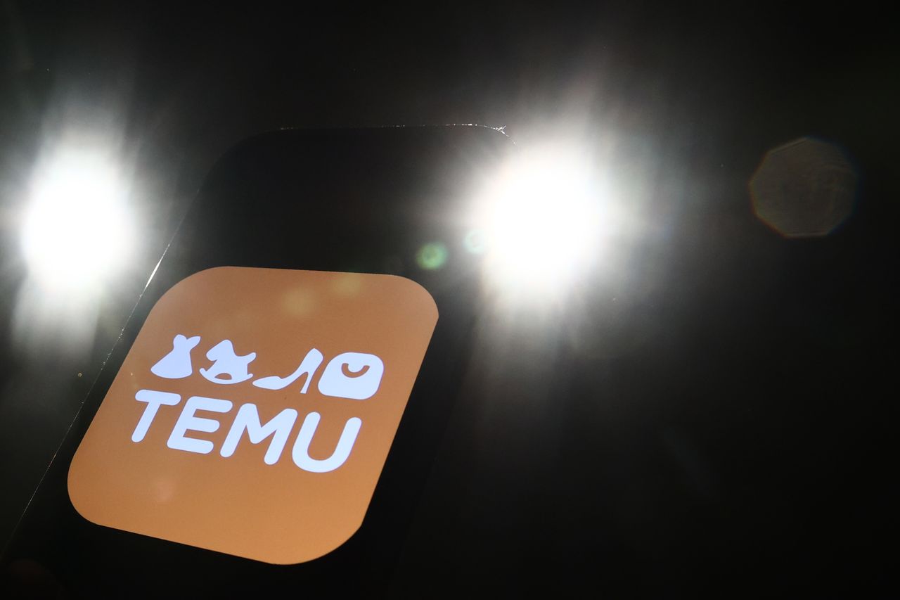 Lights and Temu logo displayed on a phone screen are seen in this illustration photo taken in Krakow, Poland on December 27, 2023. (Photo by Jakub Porzycki/NurPhoto via Getty Images)