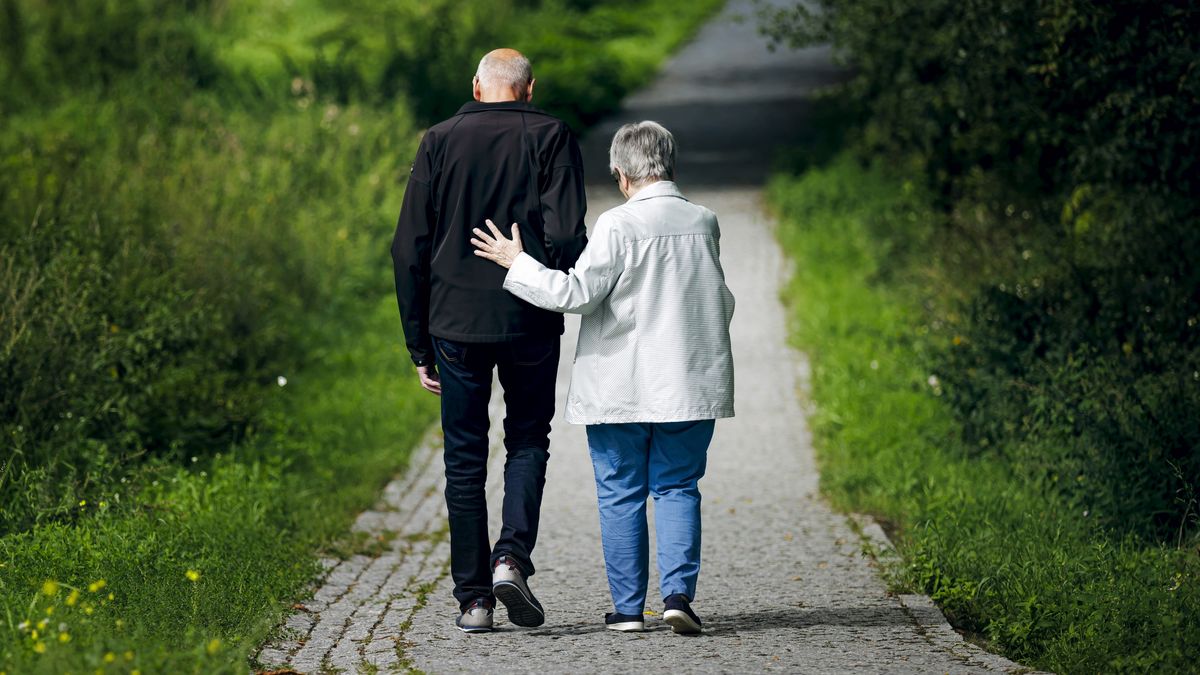 BERLIN, GERMANY - AUGUST 30: Symbolic photo on the subject of pensioners. An old married couple is walking along a path together, with the wife supporting her husband on August 30, 2023 in Berlin, Germany. (Photo Illustration by Thomas Trutschel/Photothek via Getty Images)