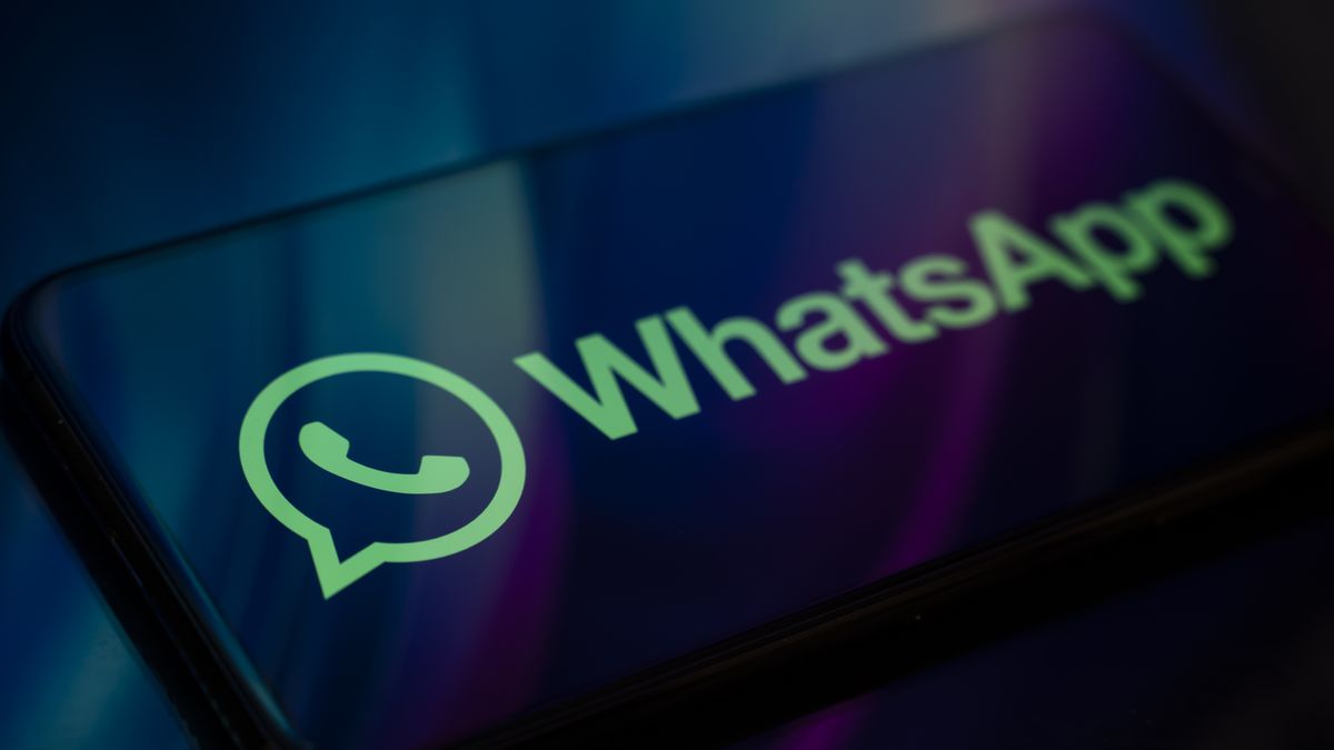 In Créteil, France, on September 29, 2025, the WhatsApp logo appears on a smartphone reflecting an abstract illustration in blue and purple colors. Meta, the parent company of WhatsApp and Meta AI, makes the Artificial Intelligence assistant mandatory in its instant messaging app. (Photo Illustration by Samuel Boivin/NurPhoto via Getty Images)
