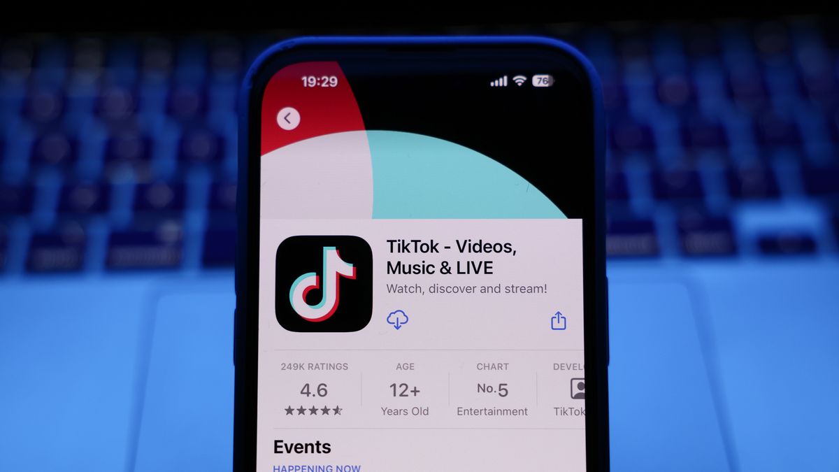 A laptop keyboard and TikTok on App Store displayed on a phone screen are seen in this illustration photo taken in Krakow, Poland on March 17, 2025. (Photo by Jakub Porzycki/NurPhoto via Getty Images)