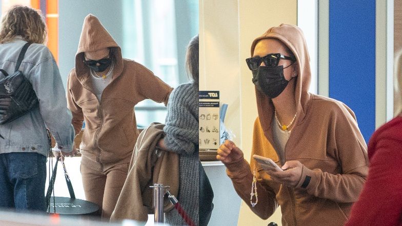 Sandra Kubicka w kapturze i okularach przeciwsłonecznych ukrywa się przed fanami (?) na lotnisku