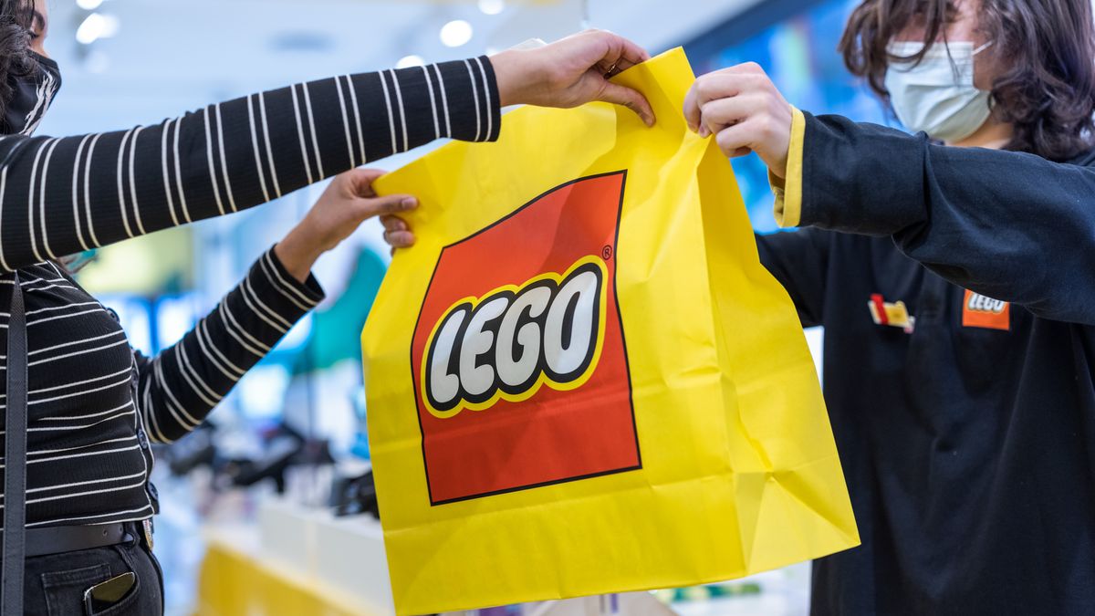 A customer is handed their purchase at the Lego A/S store in London, U.K., on Monday, March 7, 2022. The Lego Group will report their annual results on Tuesday. Photographer: Jason Alden/Bloomberg via Getty Images