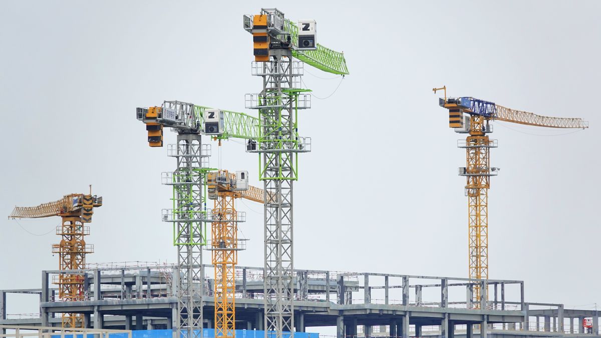 Tower cranes are being seen at a real estate construction site in Yantai, China, on May 19, 2024. (Photo by Costfoto/NurPhoto via Getty Images)