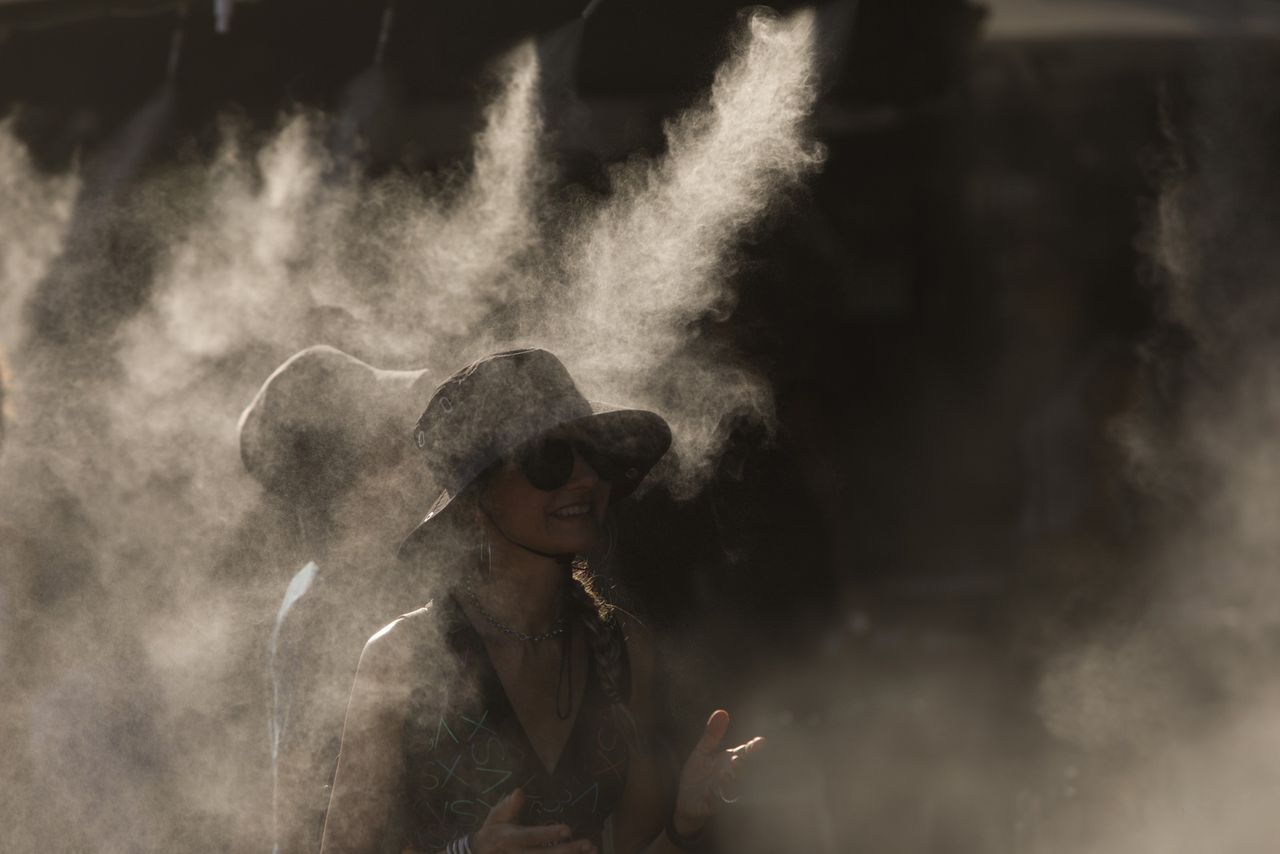 Tourists in Athens cool off at water misters in the city