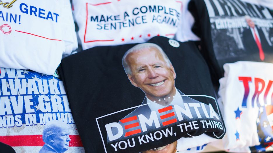 MILWAUKEE, WISCONSIN, UNITED STATES - 2024/07/16: A vendor sells t-shirts of a photo of president Joe Biden with the word, "Dementia," outside Finserv Forum on the second day of the Republican National Convention (RNC). The Republican National Convention (RNC) is going on as planned despite the assassination attempt against Trump will conclude with him accepting his party's presidential nomination. (Photo by Jeremy Hogan/SOPA Images/LightRocket via Getty Images)