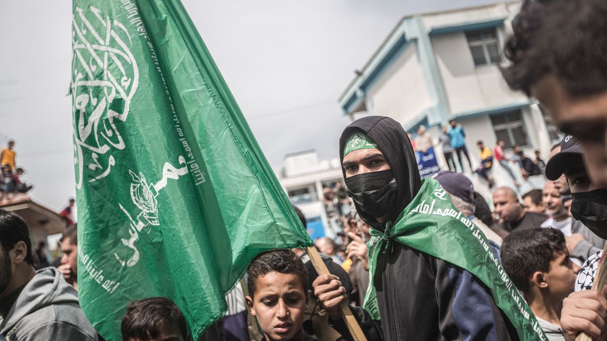 GAZA, PALESTINE - 2022/04/22: A Palestinian supporter of the Islamic movement Hamas holds a flag during a solidarity demonstration in northern Gaza City. Thousands of Palestinians joined a rally in northern Gaza City on Friday to protest against Israeli incursions into the Al-Aqsa Mosque. Al-Aqsa Mosque, located in the Old City of Jerusalem, is the third holiest site in Islam. Palestinians were enraged by Israeli police who stormed the Al Aqsa mosque. The Palestinian Red Crescent reported that 57 people were wounded in clashes at the mosque. (Photo by Yousef Masoud/SOPA Images/LightRocket via Getty Images)