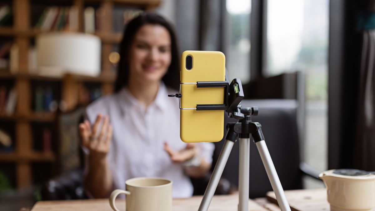 Happy young Caucasian millennial or gen z woman with long brunette hair streaming with smart phone on tripod, shooting social media blog in modern cafe. Influencer using social networks indoor.
Happy young Caucasian millennial or gen z woman with long brunette hair streaming with smart phone on tripod, shooting social media blog in modern cafe. Influencer using social networks indoor. High quality photo
person, technology, lifestyle, influencer, woman, online, internet, streaming, video, young, female, business, camera, happy, filming, smiling, blogger, communication, digital, indoor, social media, adult, live, cafe, media, smartphone, tutorial, tripod, beauty, live streaming, broadcast, marketing, recording, fashion, one person, photography, blog, talking, modern, girl, beautiful, side hustle, vlogging, vlog, cyberspace, review, hobby, selfie, connection, content, wireless technology, podcast, confidence, explaining, audience, stylish, teaching, video call, freelance work, media equipment, advice, celebrity, gesturing, device, webinar, restaurant