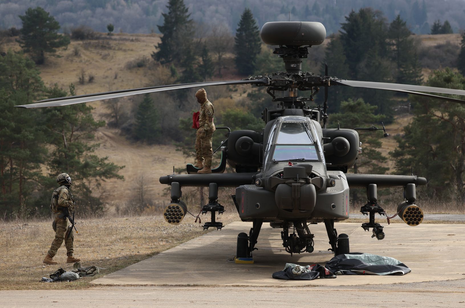 HOHENFELS, GERMANY - MARCH 12: Crew members ready a Boeing AH-64 Apache attack helicopter of the U.S. Army 12th Combat Aviation Brigade during the Allied Spirit 25 military exercise at the U.S. 7th Army Training Command Joint Multinational Readiness Center on March 12, 2025 near Hohenfels, Germany. Approximately 3,000 troops from NATO member countries, including the United States, Austria, the Czech Republic, France, Hungary, Italy, Spain, Latvia, Lithuania, North Macedonia, Slovakia, Slovenia and the United Kingdom, are participating in the four-week exercise with the aim of improving interoperability. European countries have pledged large-scale defence spending following doubts cast by the administration of U.S. President Donald Trump on the future of the U.S. commitment to the NATO military alliance. (Photo by Sean Gallup/Getty Images)