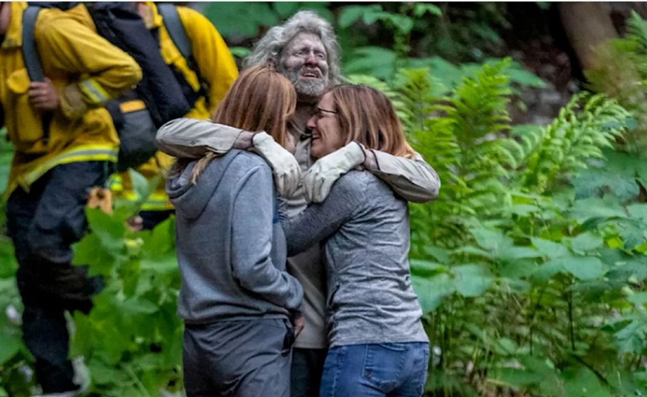 A man in the embrace of his family.