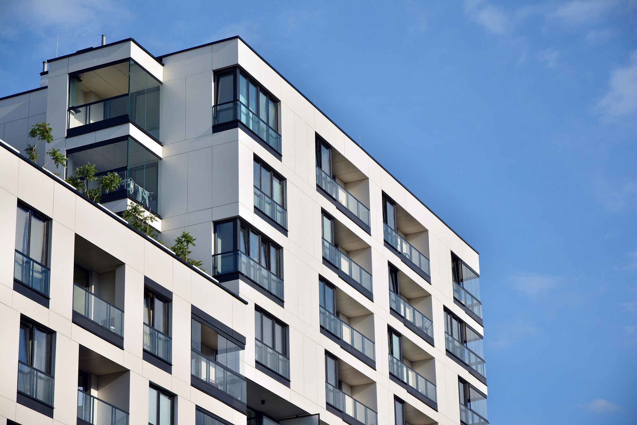 Modern apartment buildings on a sunny day with a blue sky.
Facade of a modern apartment building
Grand Warszawski
