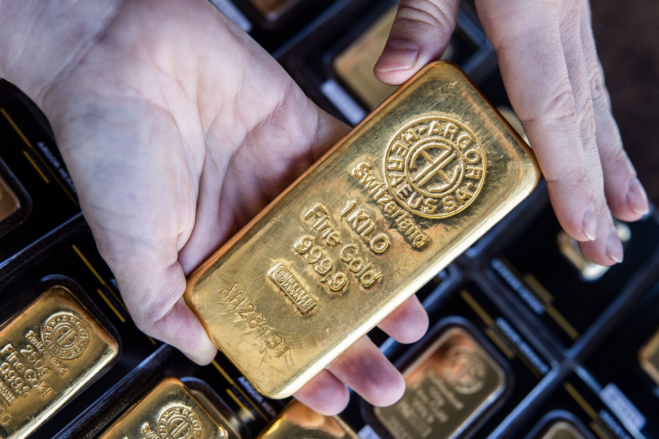 A worker handles an Argor-Heraeus SA one kilogram gold bar at Solar Capital Gold Zrt. arranged in Budapest, Hungary, on Tuesday, March 22, 2022. Gold edged higher in Asian trading -- following its biggest weekly drop since June -- as investors weighed monetary policy tightening in the U.S. against the impact of the Russia-Ukraine war. Photographer: Akos Stiller/Bloomberg via Getty Images