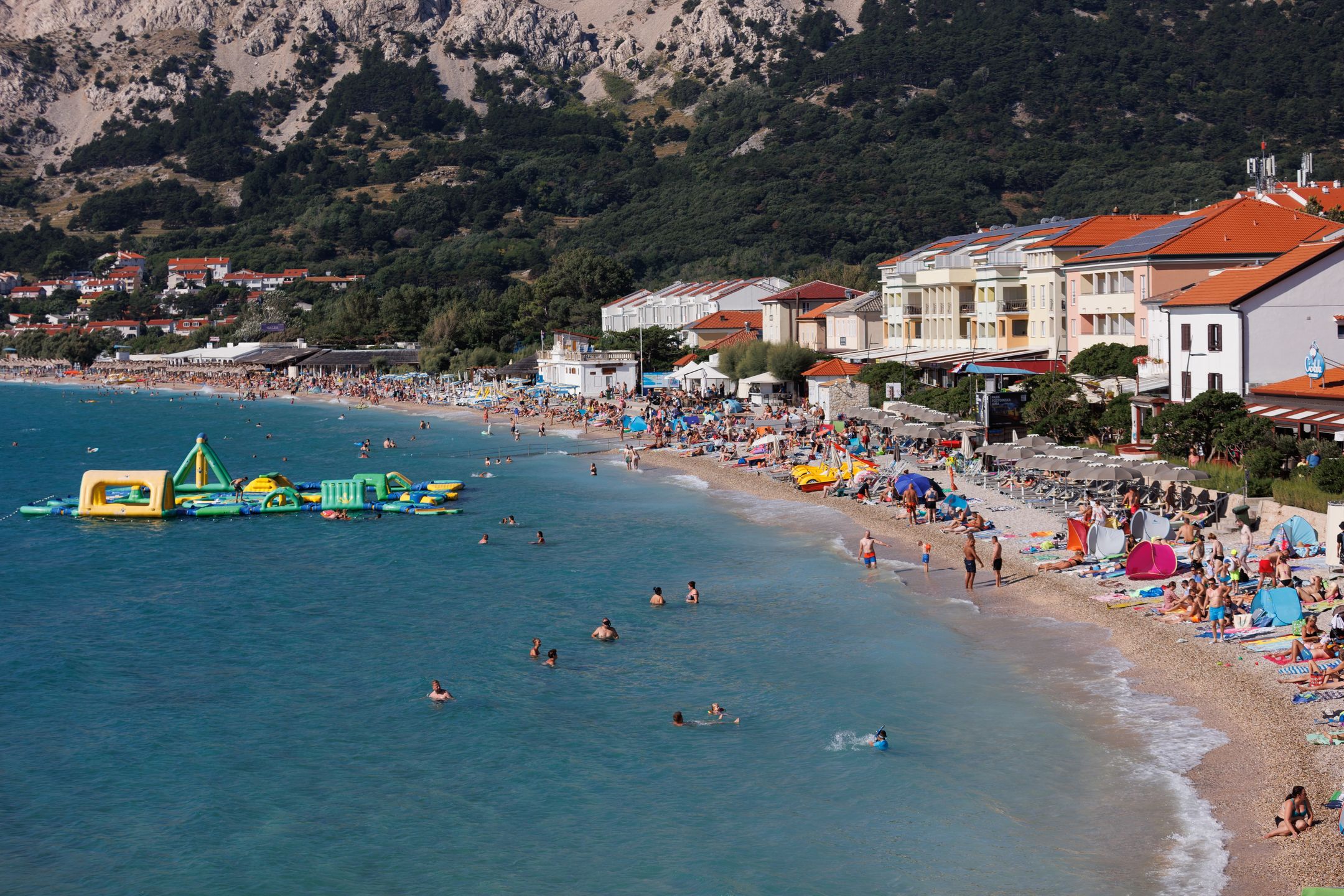 People are seen at city beach in Baska at Island Krk, Croatia on August15, 2023. This year's tourist season is at the level of the pre-pandemic, record-breaking 2019. Croatia is now recording 12.5 million arrivals and 63 million overnight stays. (Photo: Nel Pavletic/PIXSELL/DeFodi Images News/Getty Images)