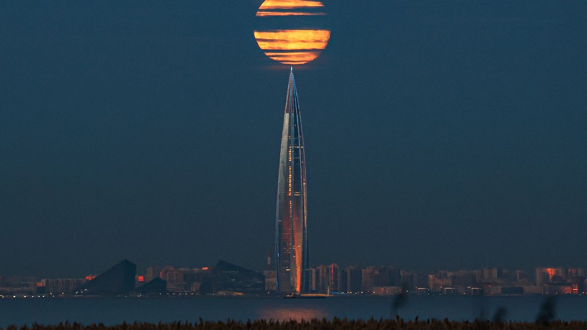 ST  PETERSBURG, RUSSIA - 2024/10/19: Moonrise in the sky above the Lakhta Center business and public complex with the Gazprom headquarters in St. Petersburg, Russia. A supermoon is an astronomical phenomenon when the full moon coincides with the passage of the point of closest approach of the Moon and Earth - perigee.The next final supermoon of 2024 will be on November 15. (Photo by Artem Priakhin/SOPA Images/LightRocket via Getty Images)