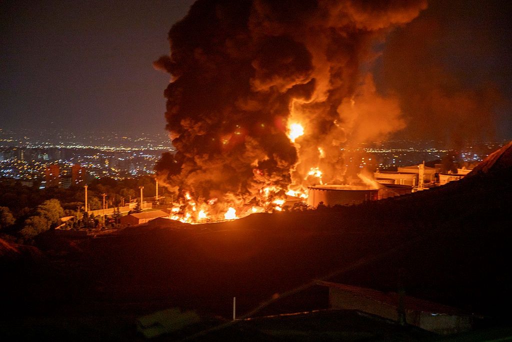 Iran Calls Israeli Strikes 'Declaration Of War' As Region Braces For Escalation
TEHRAN, IRAN - JUNE 15: Fire and smoke rise into the sky after an Israeli attack on the Shahran oil depot on June 15, 2025 in Tehran, Iran. Iran's foreign minister said the country would respond decisively and proportionally to a wave of attacks that Israel launched beginning in the early hours of June 13. The attacks targeted multiple military, scientific and residential locations, as well as senior government officials. (Photo by Stringer/Getty Images)
Getty Images