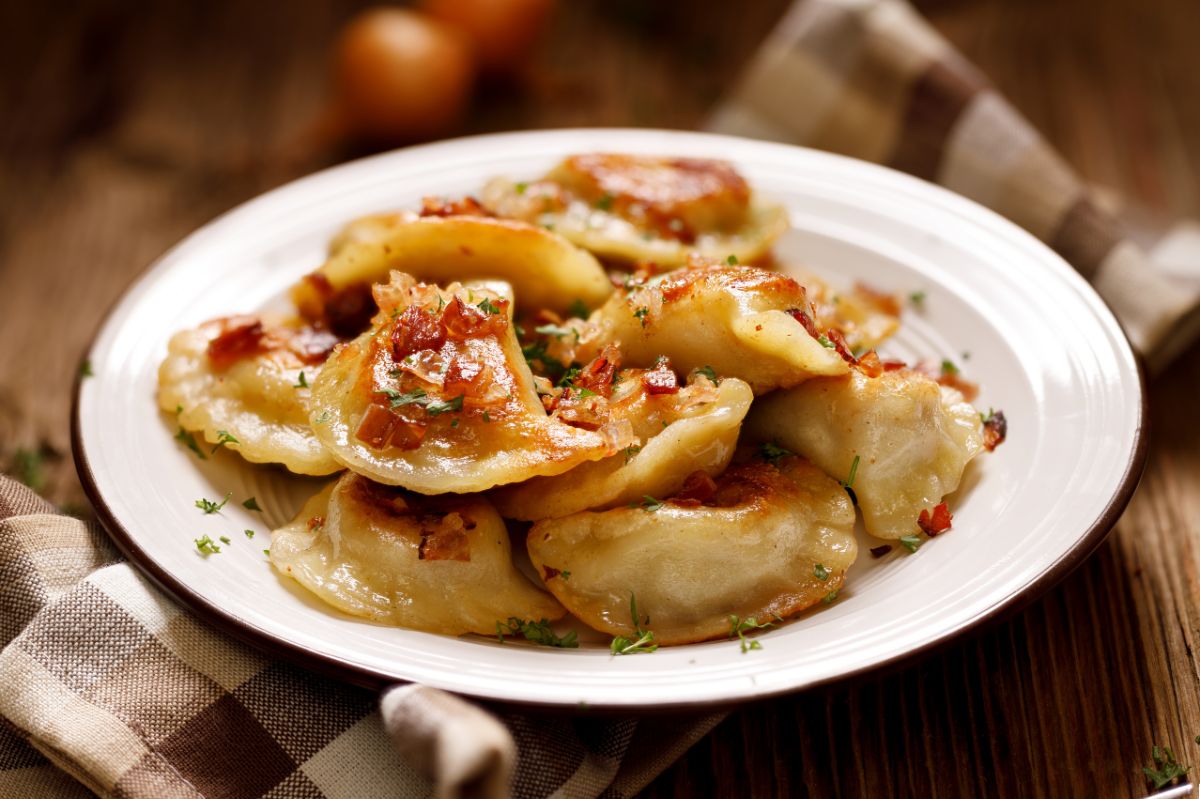 Add during frying. You will completely change the taste of the pierogi.