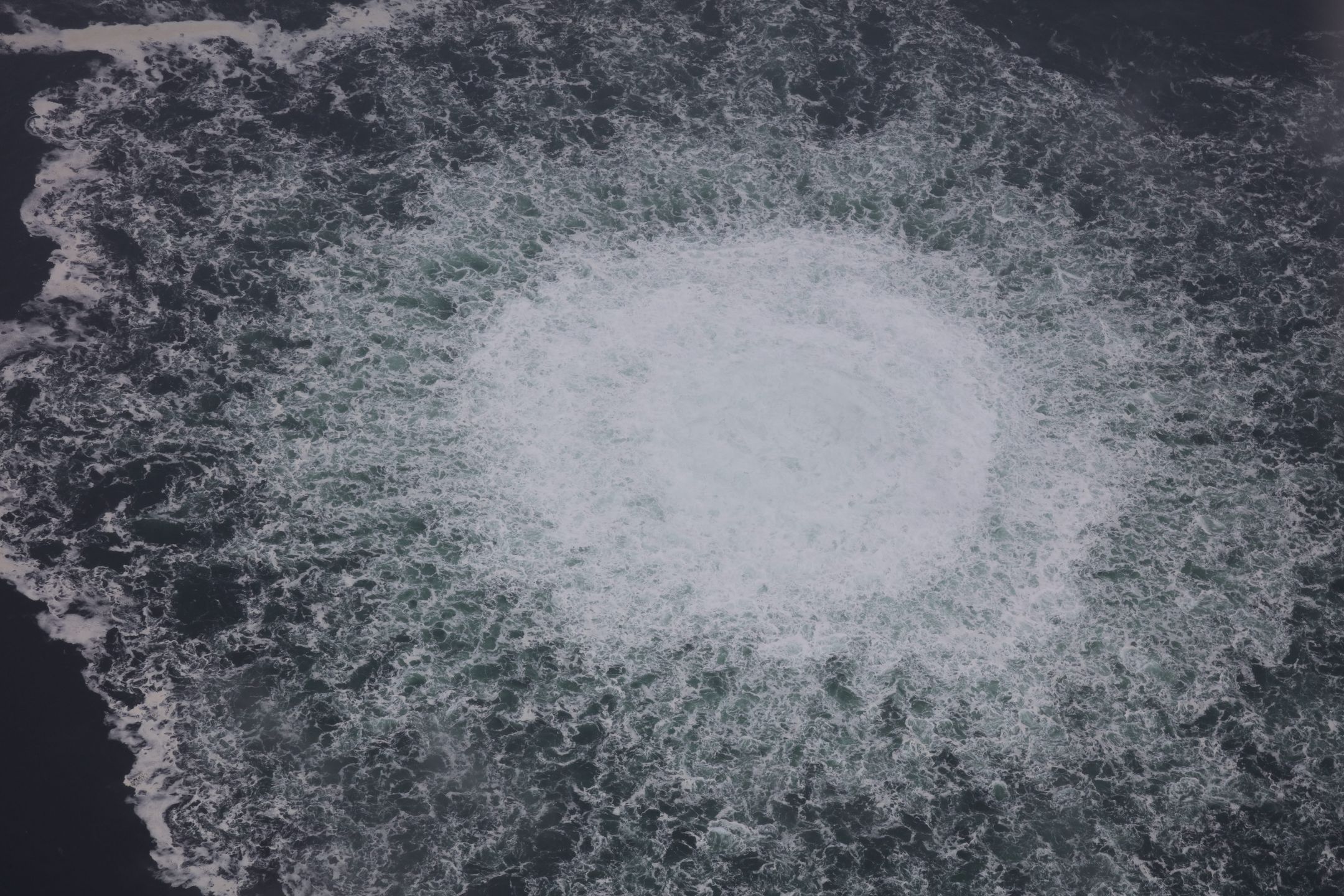 AT SEA, SWEDEN - SEPTEMBER 29: (----EDITORIAL USE ONLY - MANDATORY CREDIT - "SWEDISH COAST GUARD / HANDOUT" - NO MARKETING NO ADVERTISING CAMPAIGNS - DISTRIBUTED AS A SERVICE TO CLIENTS----) A gas leak causes bubbles on the surface of the water at Sea in Sweden on September 29, 2022. A fourth leak was reported Thursday in the Nord Stream gas pipelines off the coast of Sweden, authorities said. "There are two emissions in the Swedish economic zone, a larger one at Nord Stream 1 and a smaller one at Nord Stream 2," the Swedish Coast Guard said in a press statement. (Photo by Swedish Coast Guard / Handout/Anadolu Agency via Getty Images)